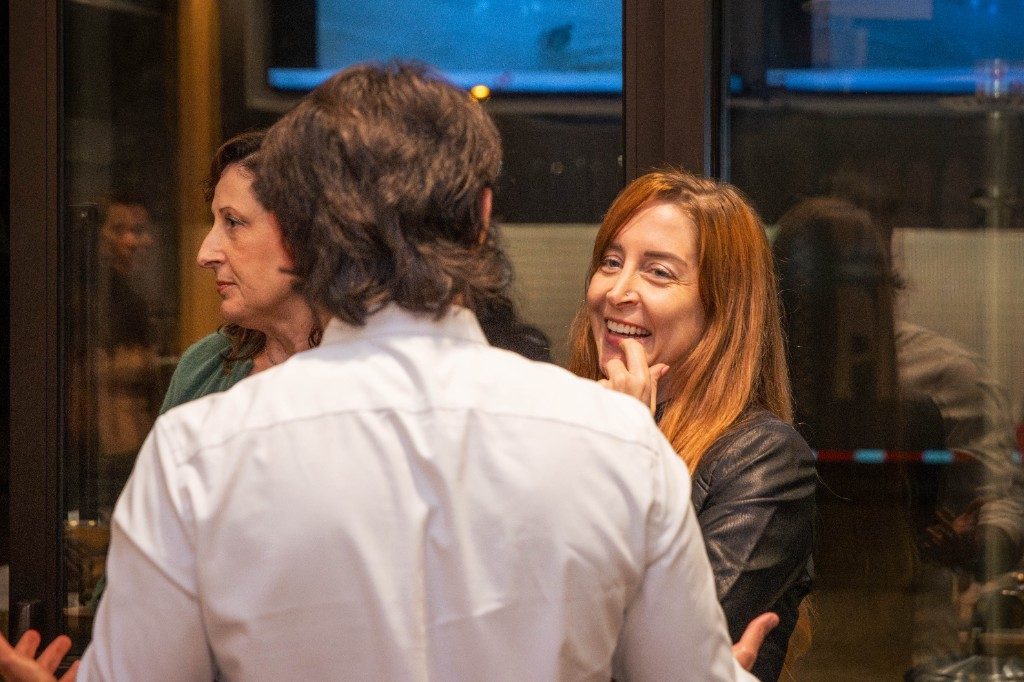 Guests talking and laughing during a cooking class